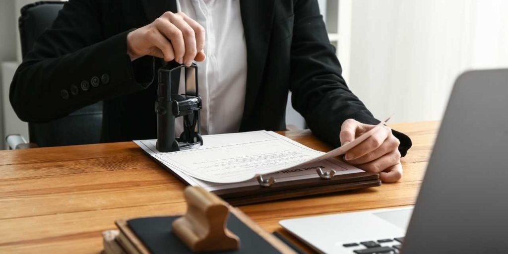 A lawyer or notary puts a seal on the document